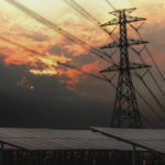 electricity pylon with solar panels and sunset. concept cleans e