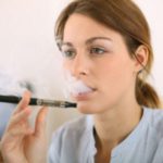 20199454 – portrait of woman smoking with electronic cigarette