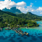 Bora Bora aerial drone image of travel vacation paradise and overwater bungalows