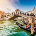 Panoramic view of Canal Grande with famous Rialto Bridge at suns
